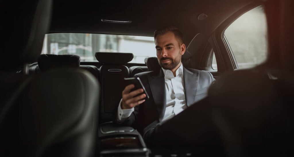 Business man in luxury transfer vehicle